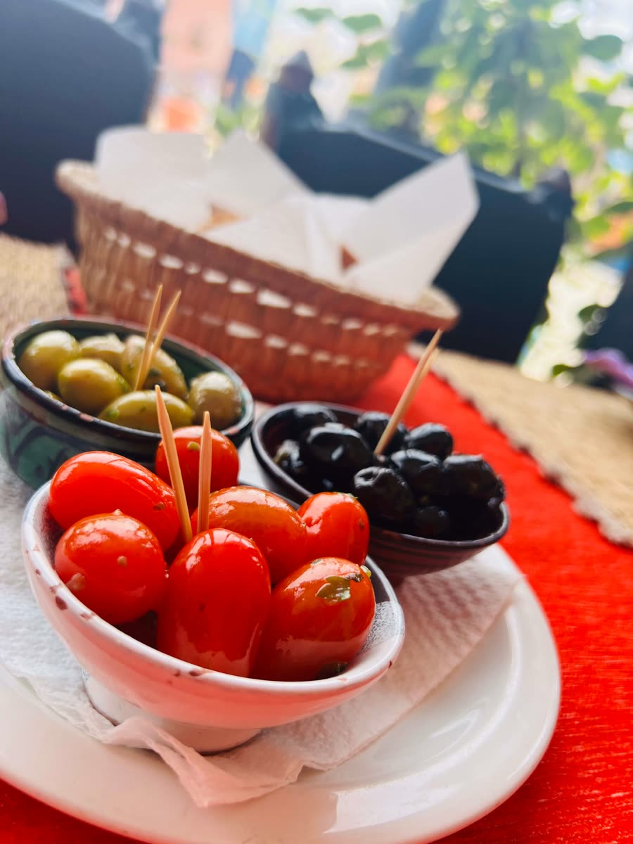 Moroccan appetizers — green and black olives with marinated cherry tomatoes at a Mirleft café